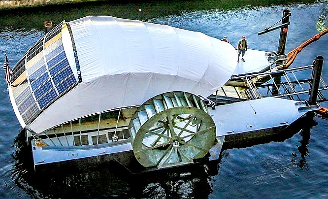 Solar and water powered tethered river skimming barge