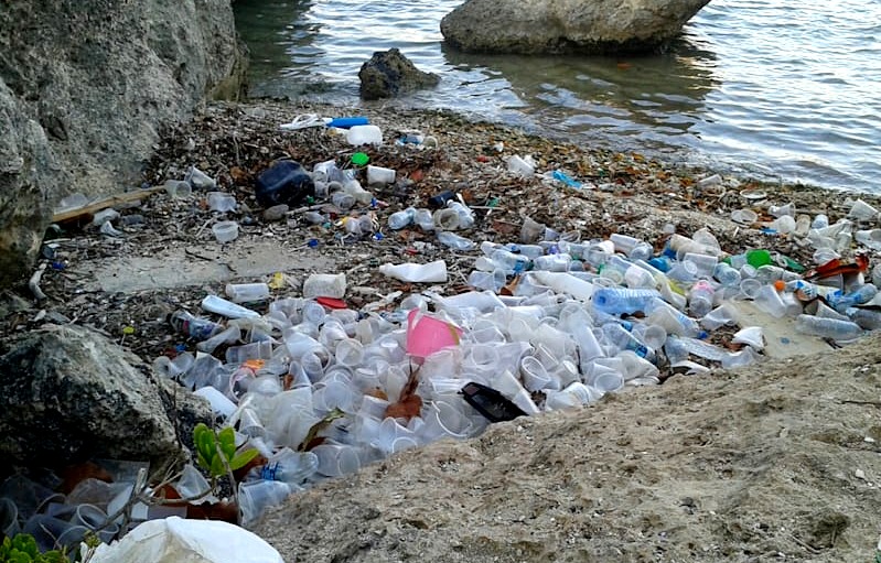 Plastic Water Bottles On The Beach Left By Tourists. Pollution In